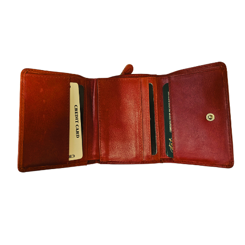 Open tri-fold red leather wallet with card slots, snap close, and zippered side pocket