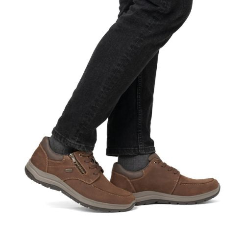 03601 Sneaker shown in brown leather with side zipper, worn with black jeans, featuring waterproof construction, comfortable cushioning, and durable rubber outsole for everyday wear and functionality