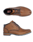 14612 Dress Boot shown in tan genuine leather with navy laces, featuring an ankle-high design, sleek silhouette, and durable rubber outsole. Top and side view displaying classic chukka boot styling with contrast stitching and layered heel construction.