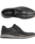 14701 Lace-Up Sneaker shown from top and side view angles in black genuine leather with cap toe detail, grey rubber sole, and brown contrast stitching. Features sleek modern design combining dress shoe elegance with sneaker comfort.