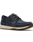 Navy blue lace up shoe with white midsole and brown outsole. Nubuck leather uppers feature white stitched detailing and 3 eyelet lace closure. 