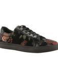 Black lace-up shoe with metallic red and green rose pattern, a black outsole, and black laces. 