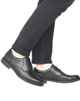 10304 Laced Dress Shoe shown on feet wearing dark jeans, displaying classic black leather oxford design with sleek silhouette, lace-up closure, and durable rubber sole for professional styling