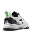 White and black pickleball shoes with green heel loop, featuring a black 7 logo and a Vibram rubber outsole.