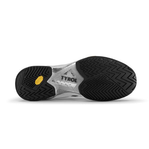 The sole of a pickleball shoe with black traction patterns, TYRO visible on a silver section, and Vibram rubber outsole.