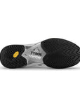 The sole of a pickleball shoe with black traction patterns, TYRO visible on a silver section, and Vibram rubber outsole.