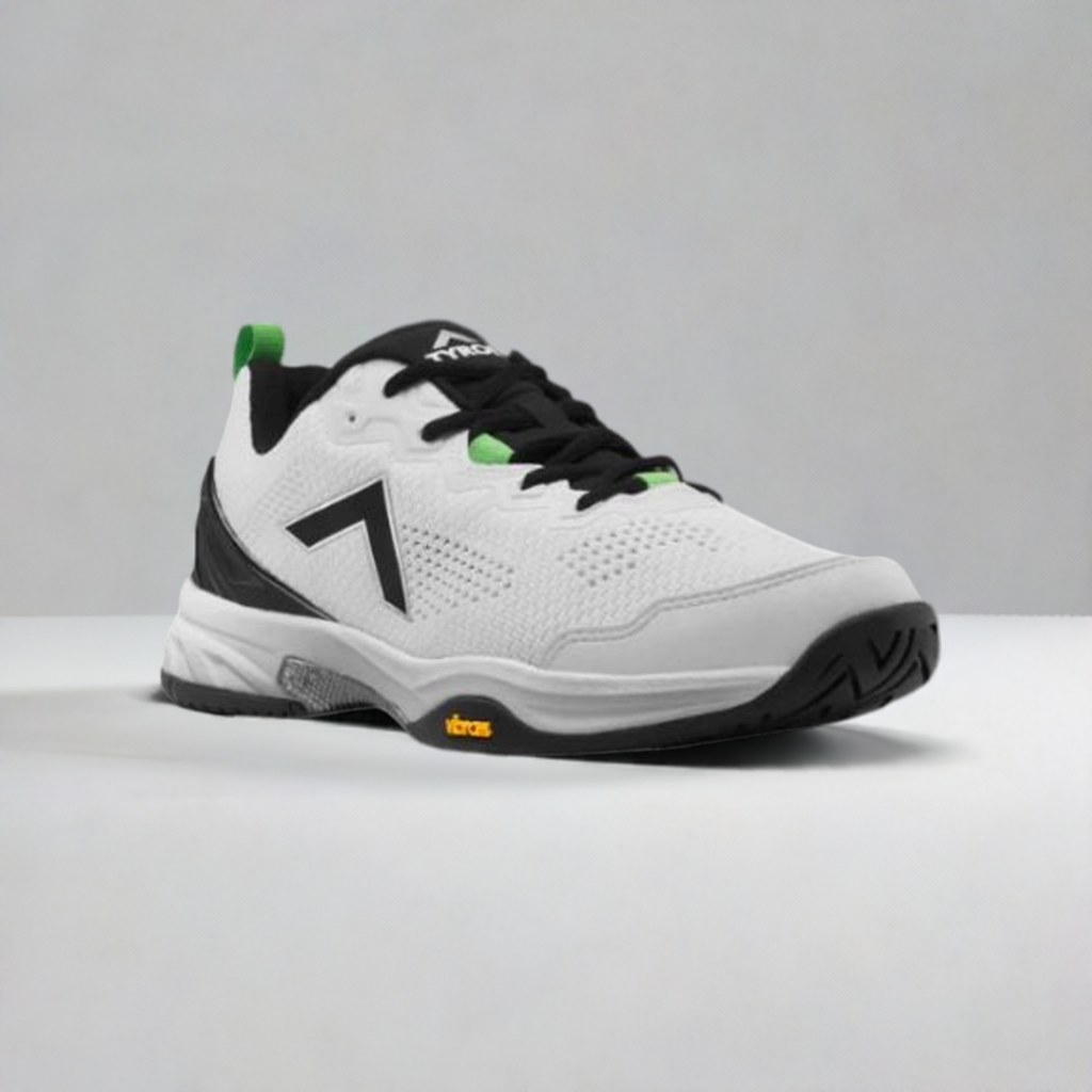 White and black pickleball shoe with green accents, unique logo, textured sole, and Vibram rubber outsole.