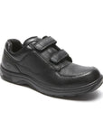 Black leather shoes with two adjustable Velcro straps and apron toe stitching. Outsole is black.