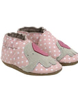 Pink leather shoes with white polka dots and an elephant design on top.