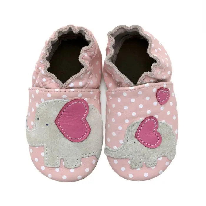 Pink leather shoes with white polka dots and an elephant design on top.