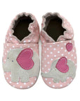 Pink leather shoes with white polka dots and an elephant design on top.