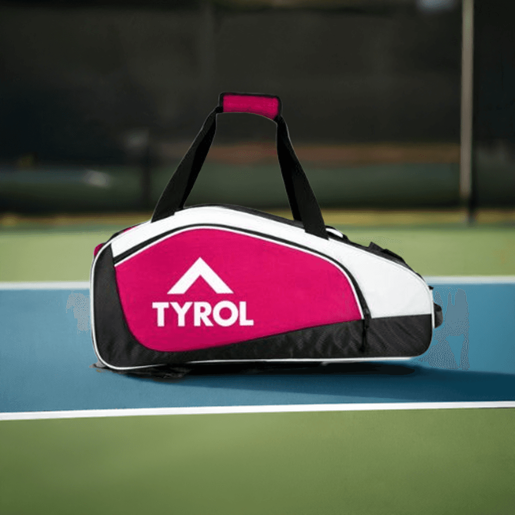 Red and white Tyrol sports bag with multiple compartments on a tennis court surface.