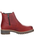 Profile view of red leather Chelsea boot with inside zipper and brown outsole.