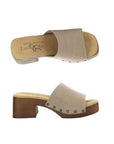 Profile and top view of Marly slide sandal with grey suede leather upper and brown block heel outsole. Tan footbed with brand logo detailing. Upper is attached to outsole with six silver rivets 