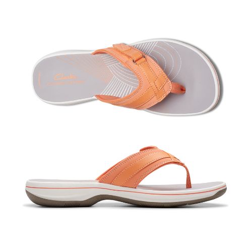 Top and profile view of Breeze Sea sandal in tangerine. Clarks branding is visible on footbed. 