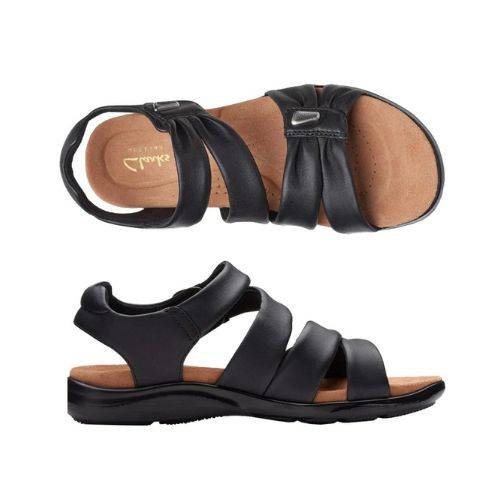 Top and profile view of Kitly Ave sandal in black. Footbed is beige with Clarks branding. Outsole is black.