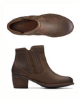 Top and profile view of Neva Zip ankle boot in taupe. Features brown elastic goring and outside zipper. 