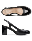 Top and profile view of Bayla Joy in black. A closed toe pump with side cutouts and a slingback heel. 