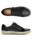 Top and profile view of Nalle sneaker in black. Clarks logo is visible on the insole. 