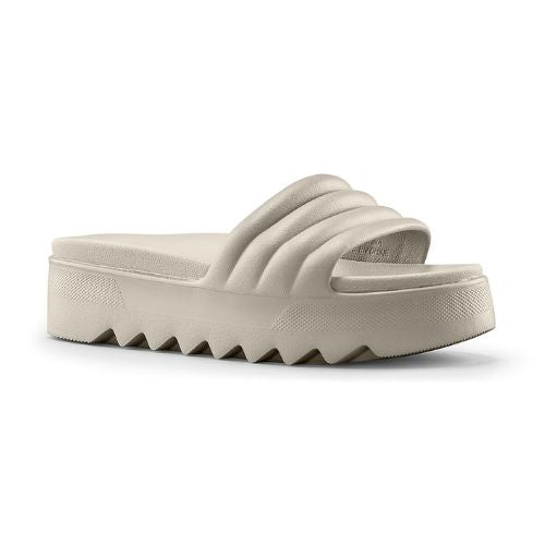 Pool Party Slide Sandal in Dove. A solid coloured, light taupe sandal with a 1.5 inch platform outsole, designed with deep grooves. 