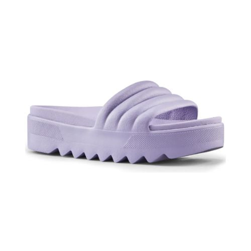 Pool Party Slide Sandal in Lavender. A solid coloured, light purple sandal with a 1.5 inch platform outsole, designed with deep grooves. 