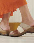 Model wearing an orange skirt walking in the Catalonia 86 Slide Sandals. 