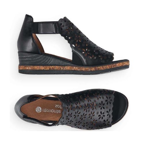 Pair of black wedge sandal with floral cut-out design and adjustable ankle strap.