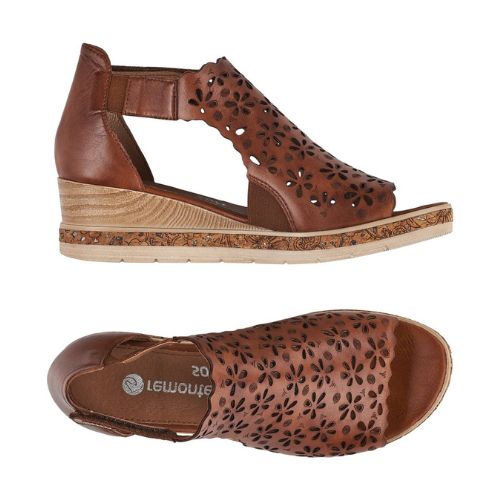 Pair of brown leather wedge sandal with floral cut-outs and velcro ankle strap.