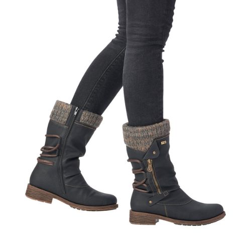 Person showcasing Remonte D8070 mid-calf boots, featuring brown accents and lambs wool lining, paired with dark jeans.