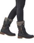 Person showcasing Remonte D8070 mid-calf boots, featuring brown accents and lambs wool lining, paired with dark jeans.