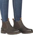 Legs in cuffed jeans wearing brown Chelsea boot with dark brown elastic goring.