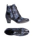 Top and side view of heeled ankle boot in blue and black with black patent toe cap. Boot has inside zipper.