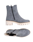 A pair of Rieker blue Chelsea boots with side zipper, white lining and a platform lugged white outsole.