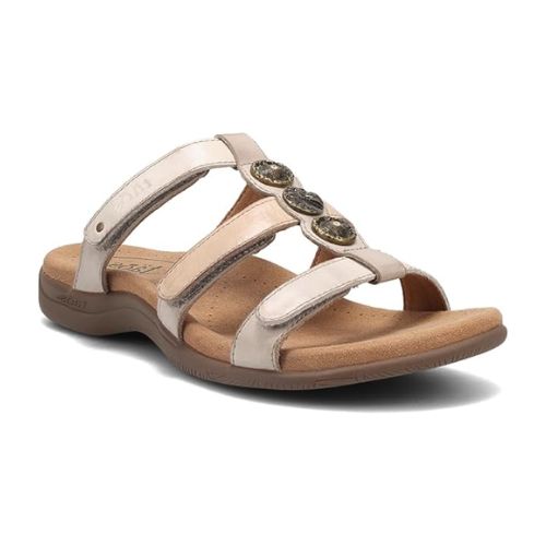 Cream leather sandal with three adjustable straps and three silver medalion details on T-strap. Sandal has brown footbed and outsole.