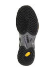 Pickleball shoe sole with black and gray zigzag pattern, Vibram logo near heel, offering lateral stability.