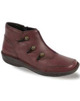 
Burgundy ankle boot with three buttons on side.