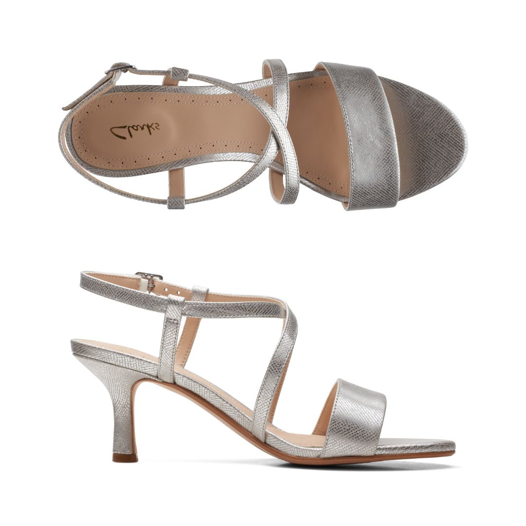 Top and profile view of silver heeled sandal. Features adjustable buckle slingback. 