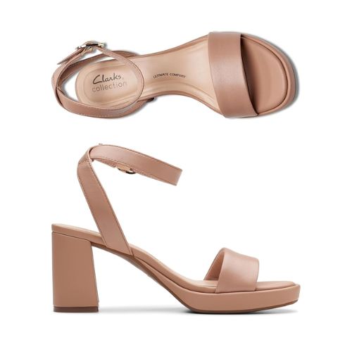 Top and profile view showing Beige ankle strap block heel with silver buckle and single strap across the open toe. Footbbed is light cream color with Clarks logo printed. Outsole is a dark brown rubber 