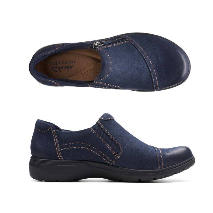 Top and side view of Carleigh Ray in navy. Brown insole with Clarks branding is visible. Shoe features blue elastic goring for easy on and off. 