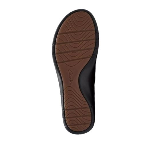 Certine Pure slip on bottom view showing brown rubber outsole with tread design in waves and line and Clarks logo stamped in middle. Outer tred is black