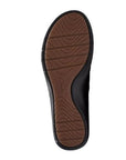 Certine Pure slip on bottom view showing brown rubber outsole with tread design in waves and line and Clarks logo stamped in middle. Outer tred is black