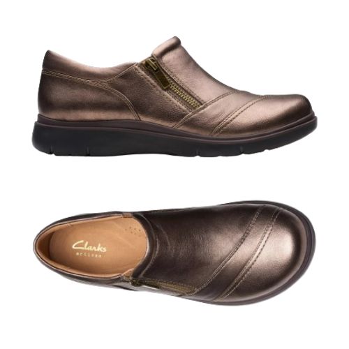 Top and profile of Bronze slip on shoe with detailed overlap upper featuring side zipper and black durable outsole. Tan footbed with gold Clarks logo