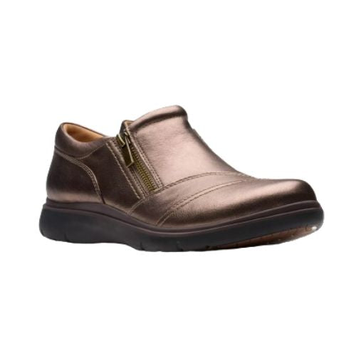 Bronze slip on shoe with detailed overlap upper featuring side zipper and black durable outsole