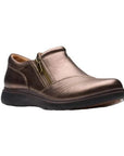 Bronze slip on shoe with detailed overlap upper featuring side zipper and black durable outsole