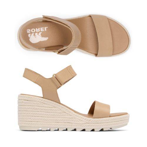 A pair of Sorels Cameron Wedge Sandal: Tan leather, adjustable strap, woven platform.