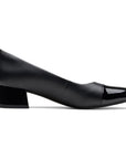 Profile view of black leather pump with patent heel and toe. 