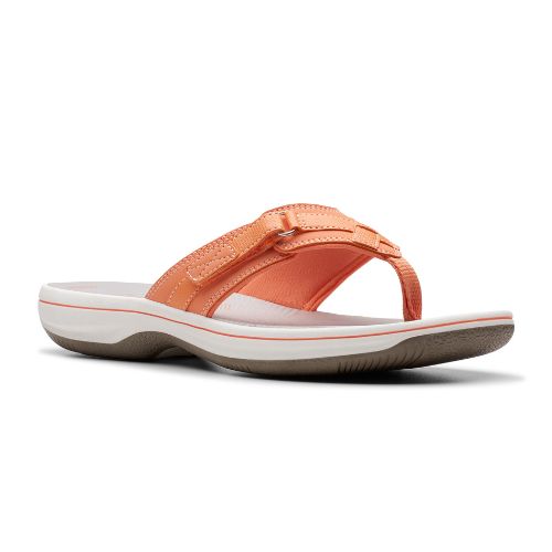 Breeze Sea thong sandal in tangerine. Light orange upper with adjustable velcro strap and fabric toe post. Footbed is grey, midsole is white, outsole is taupe. 