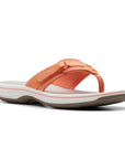 Breeze Sea thong sandal in tangerine. Light orange upper with adjustable velcro strap and fabric toe post. Footbed is grey, midsole is white, outsole is taupe. 