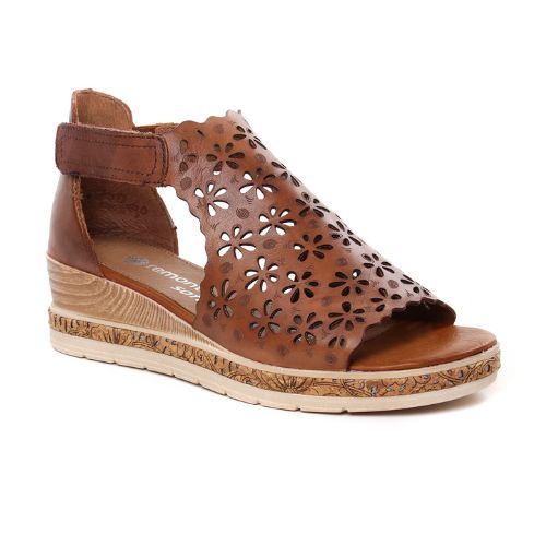 Brown leather wedge sandal with floral cut-outs and velcro ankle strap.