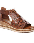 Brown leather wedge sandal with floral cut-outs and velcro ankle strap.